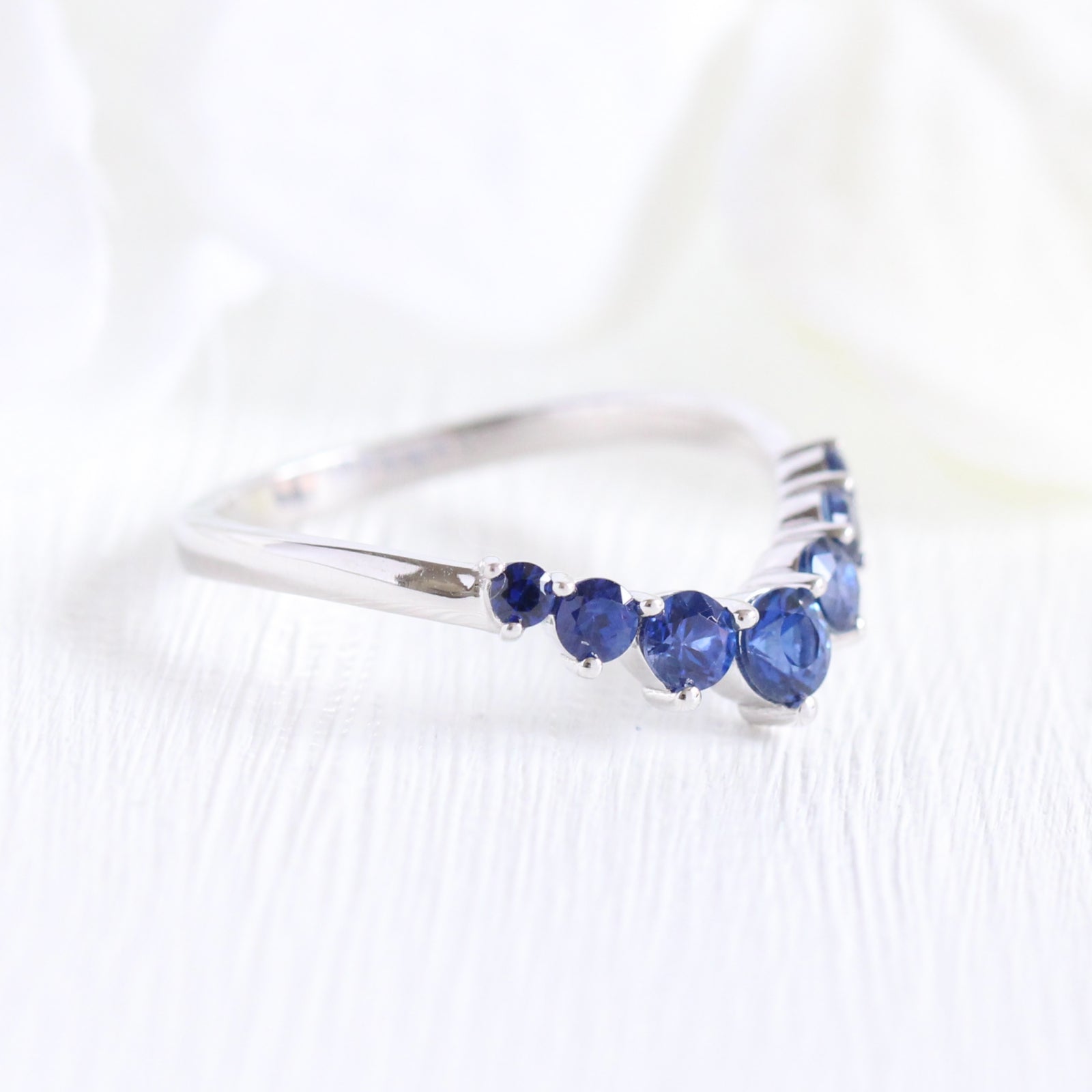 large sapphire wedding band in white gold half eternity curved wedding ring by la more design jewelry