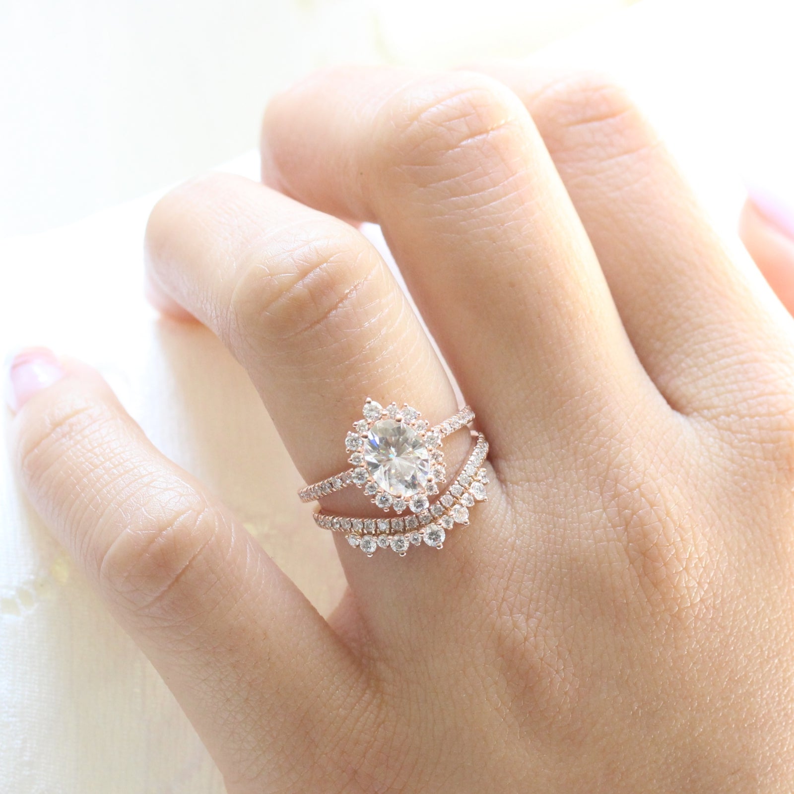 oval moissanite engagement ring halo diamond bridal set rose gold and crown diamond wedding band by la more design jewelry