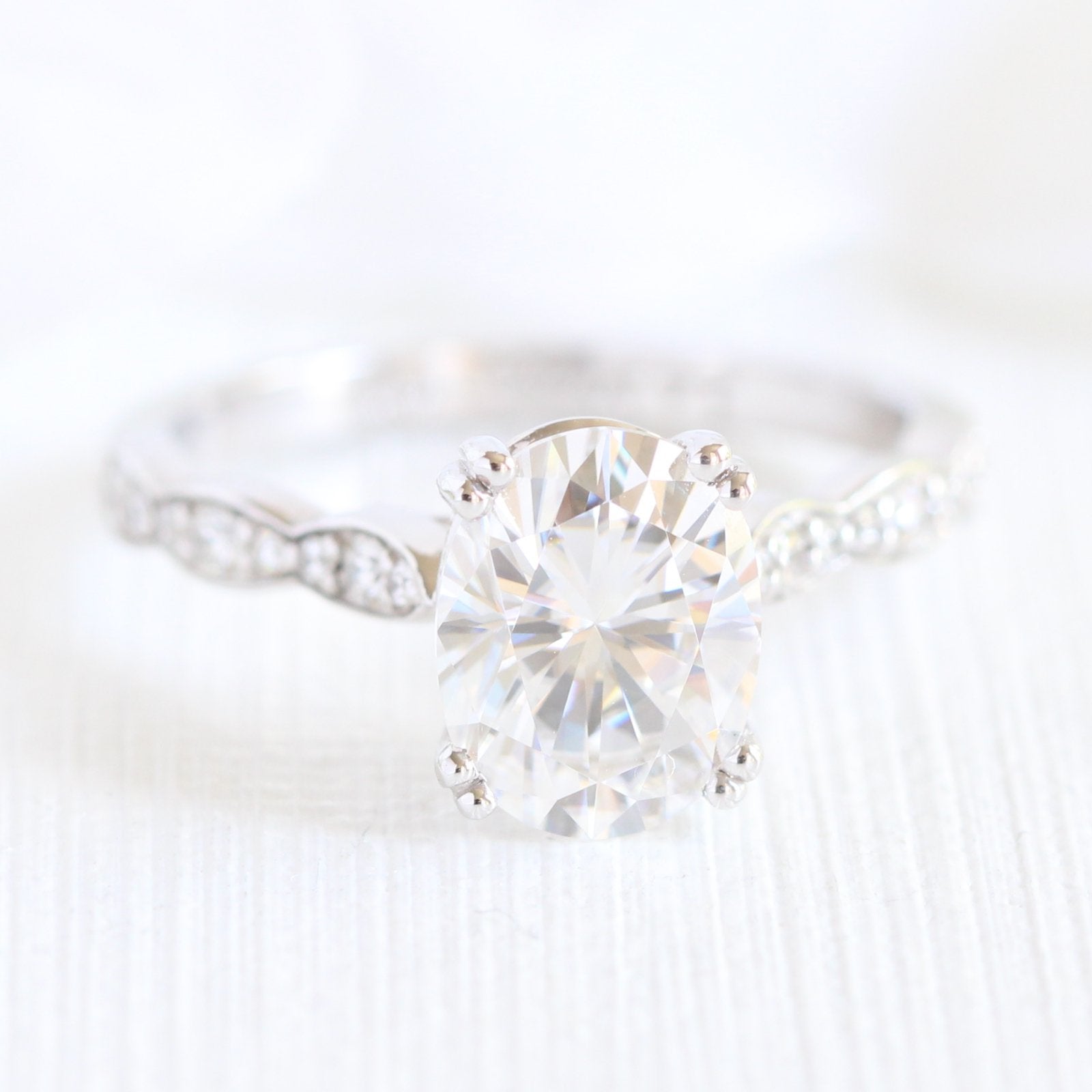 oval moissanite solitaire engagement ring in white gold scalloped diamond band by la more design