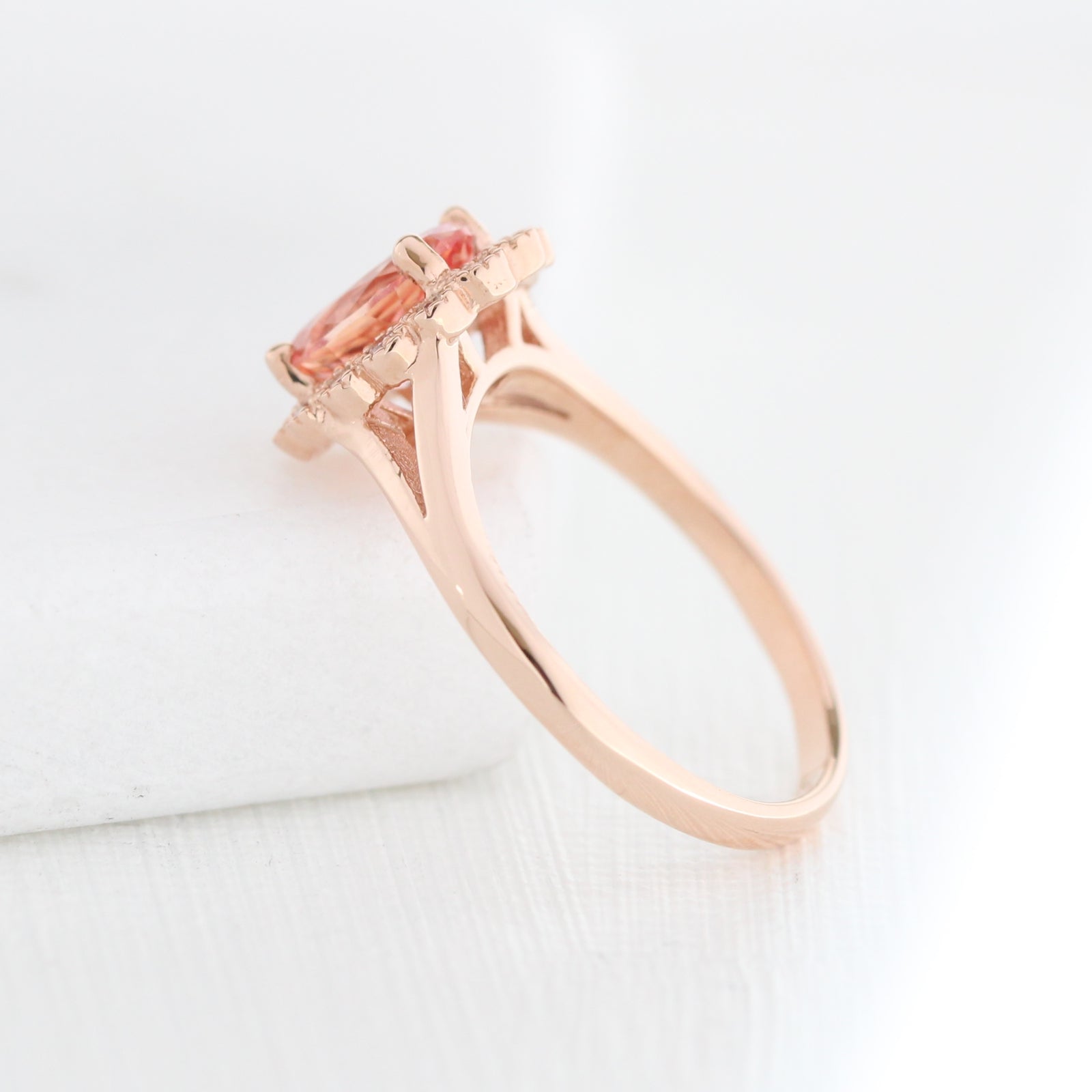 oval peach sapphire engagement ring in rose gold halo diamond band by la more design