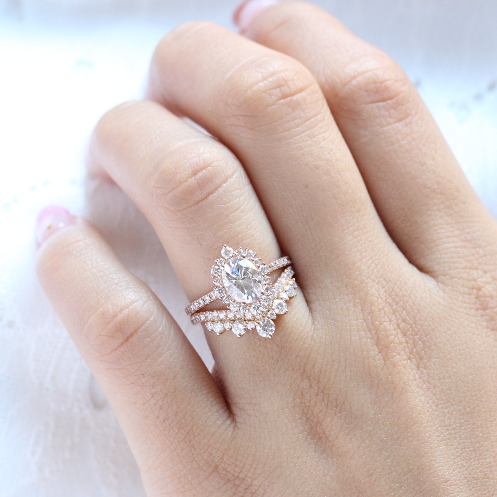 oval moissanite engagement ring rose gold halo diamond bridal set and contour diamond wedding band by la more design jewelry