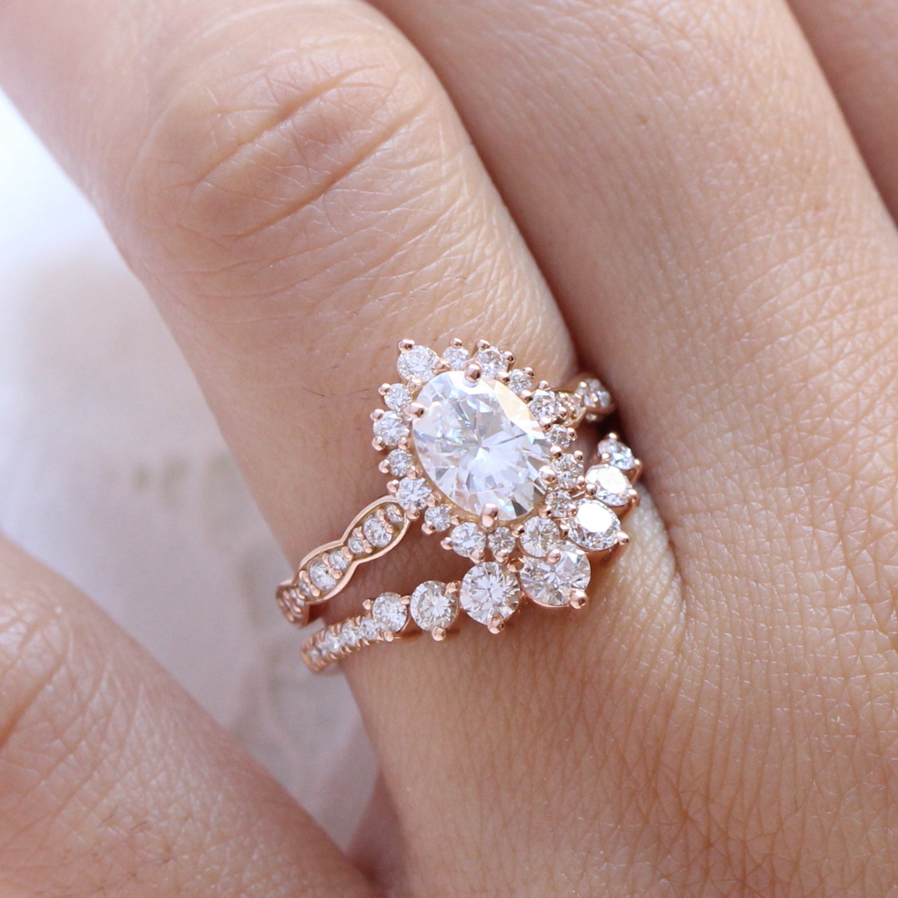 oval moissanite engagement ring rose gold halo diamond bridal set and leaf diamond wedding band by la more design jewelry