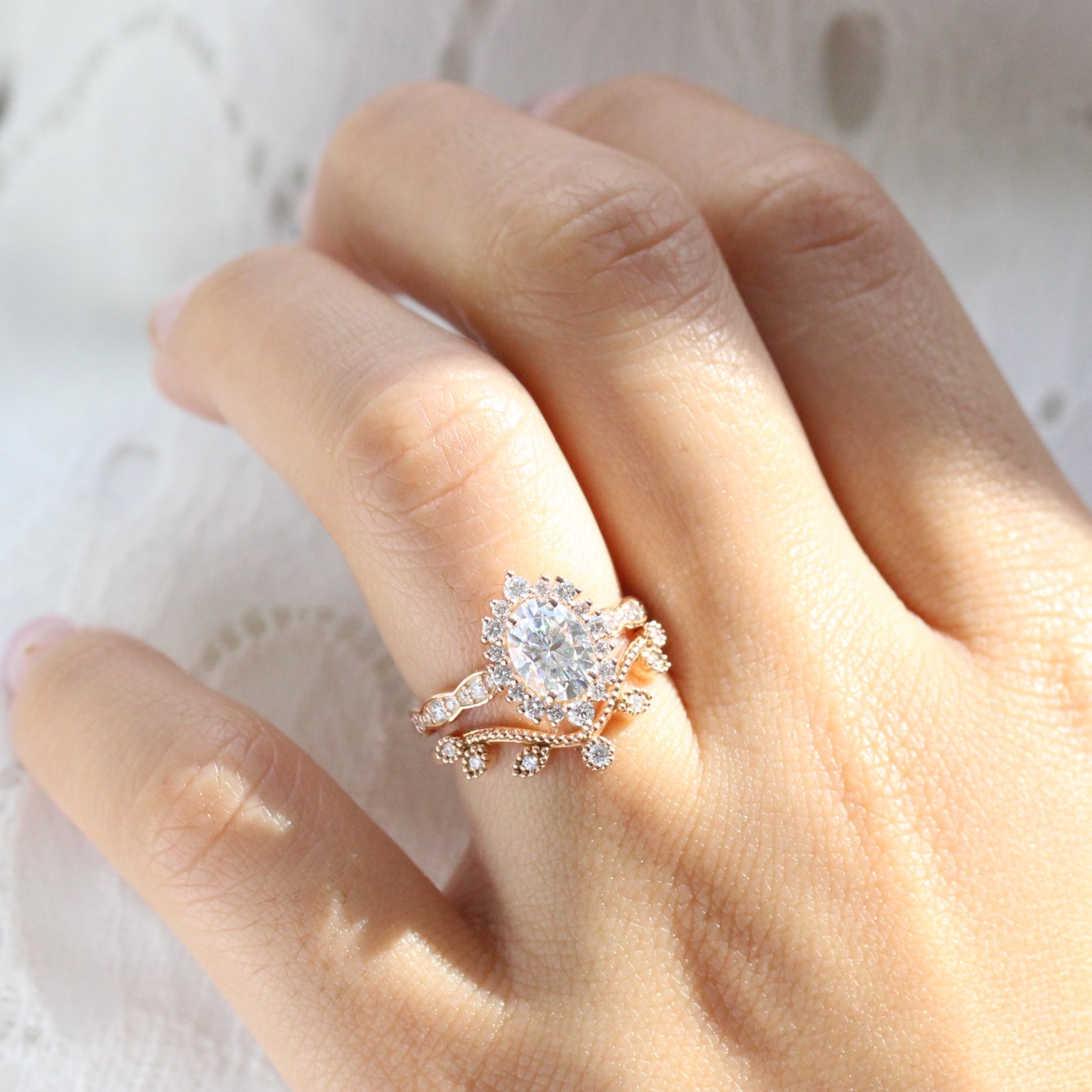 oval moissanite engagement ring rose gold halo diamond bridal set and leaf diamond wedding band by la more design jewelry