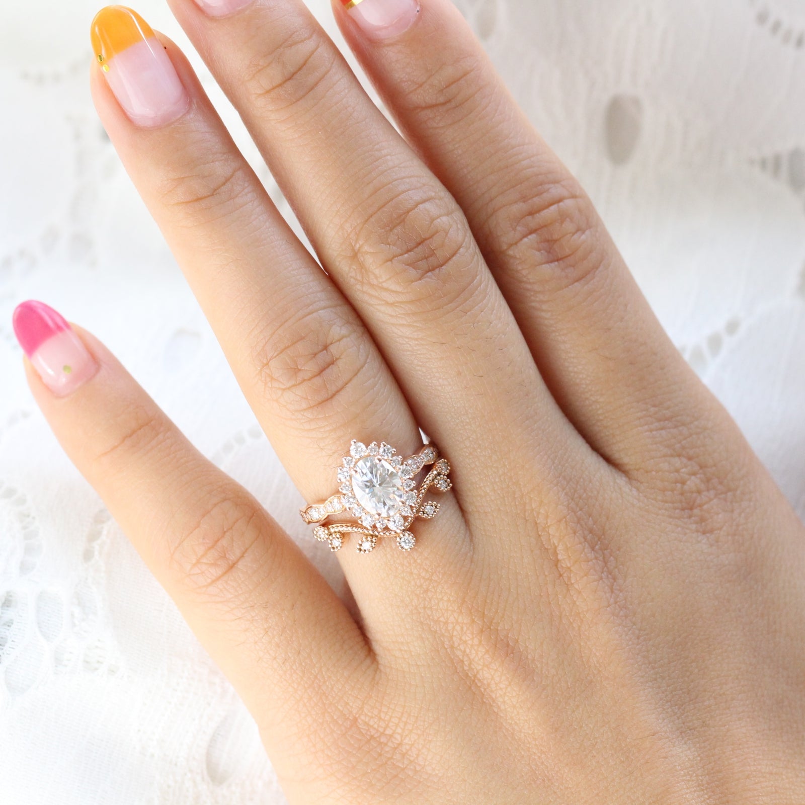 oval moissanite engagement ring rose gold halo diamond bridal set and leaf diamond wedding band by la more design jewelry
