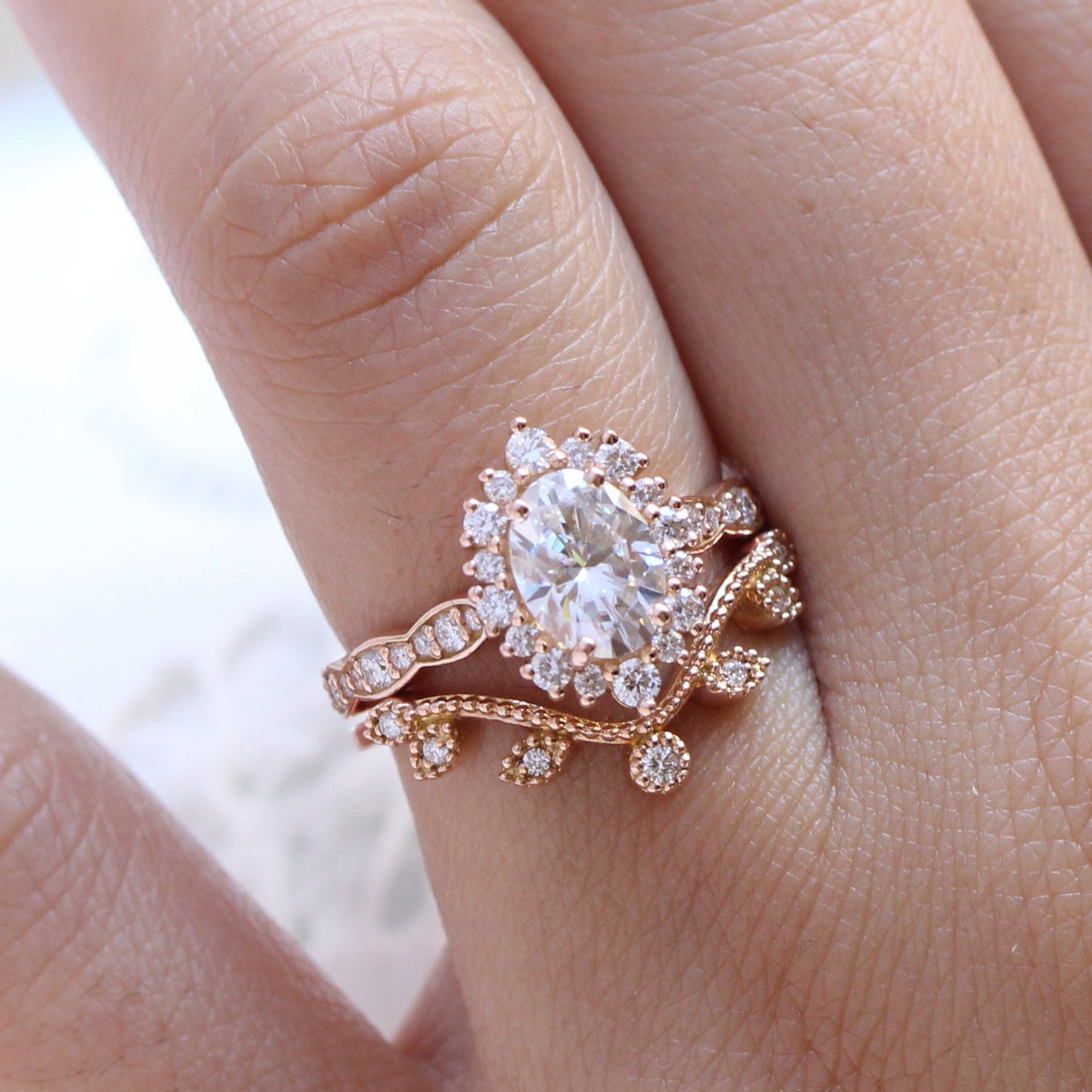 oval moissanite engagement ring rose gold halo diamond bridal set and diamond wedding band by la more design jewelry