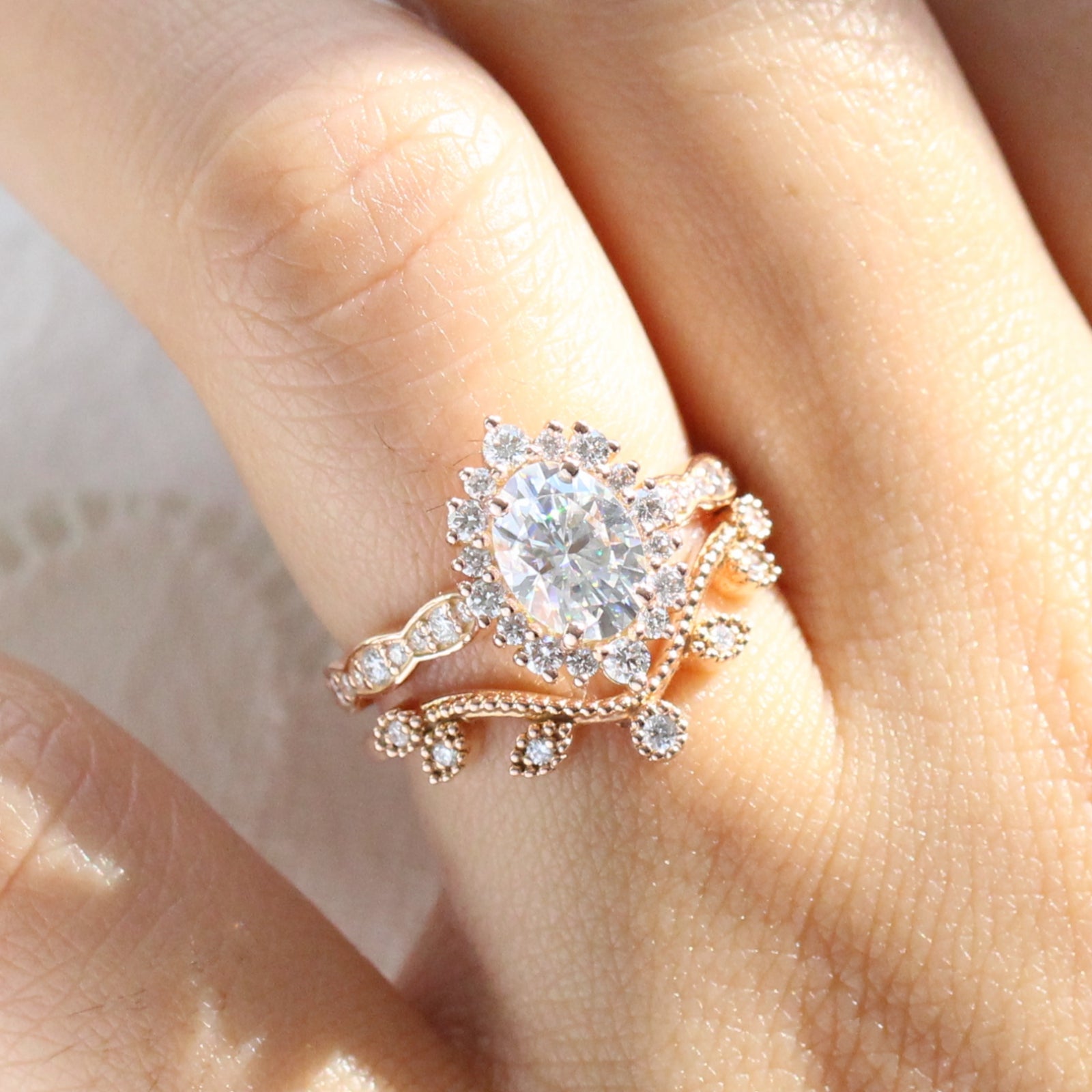 oval moissanite engagement ring rose gold halo diamond bridal set and leaf diamond wedding band by la more design jewelry