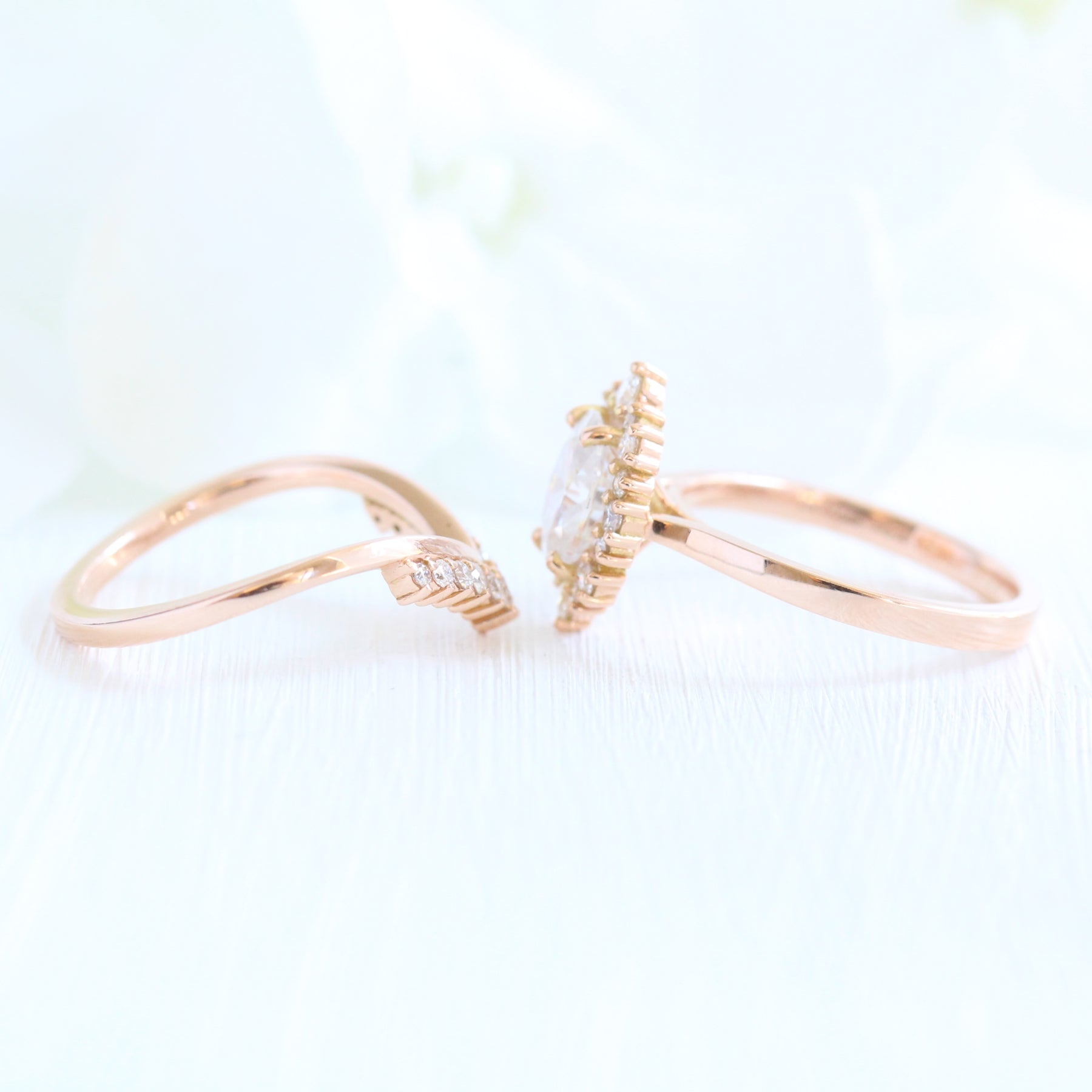oval moissanite engagement ring rose gold halo diamond bridal set and v shaped diamond wedding band by la more design jewelry