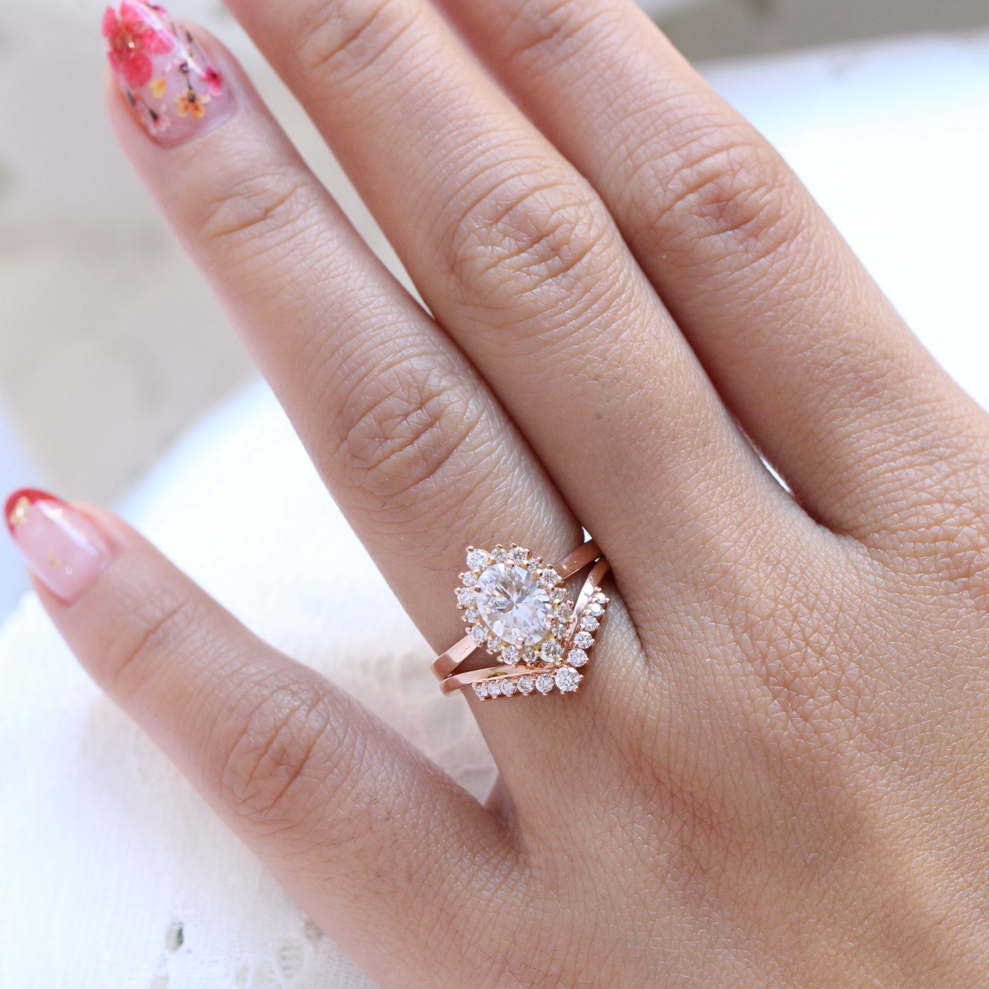 oval moissanite engagement ring rose gold halo diamond bridal set and v shaped diamond wedding band by la more design jewelry