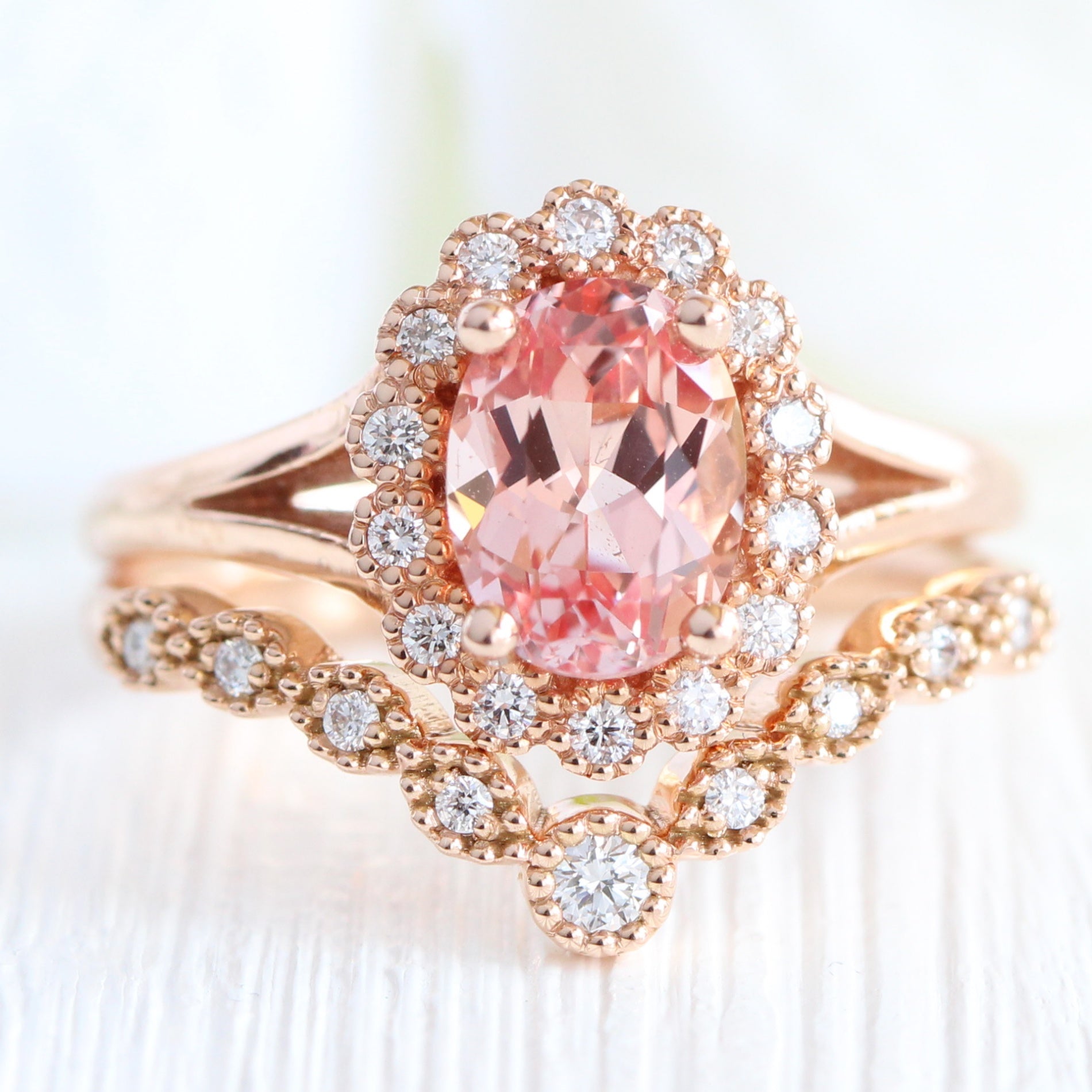 oval peach sapphire ring and curved diamond band in rose gold bridal set by la more design jewelry