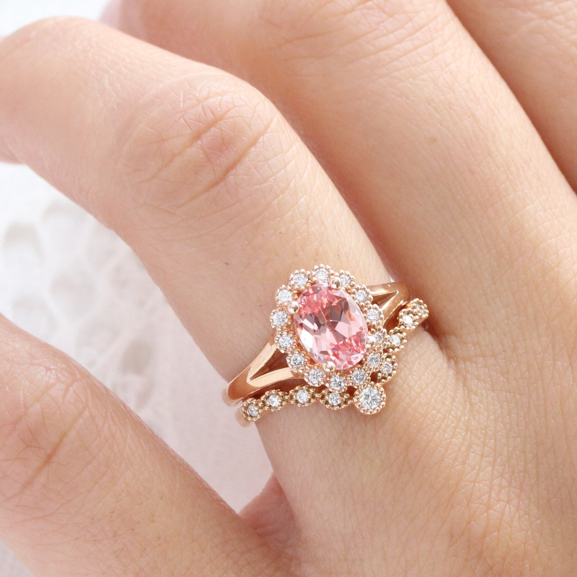 oval peach sapphire ring and curved diamond band bridal set in rose gold by la more design