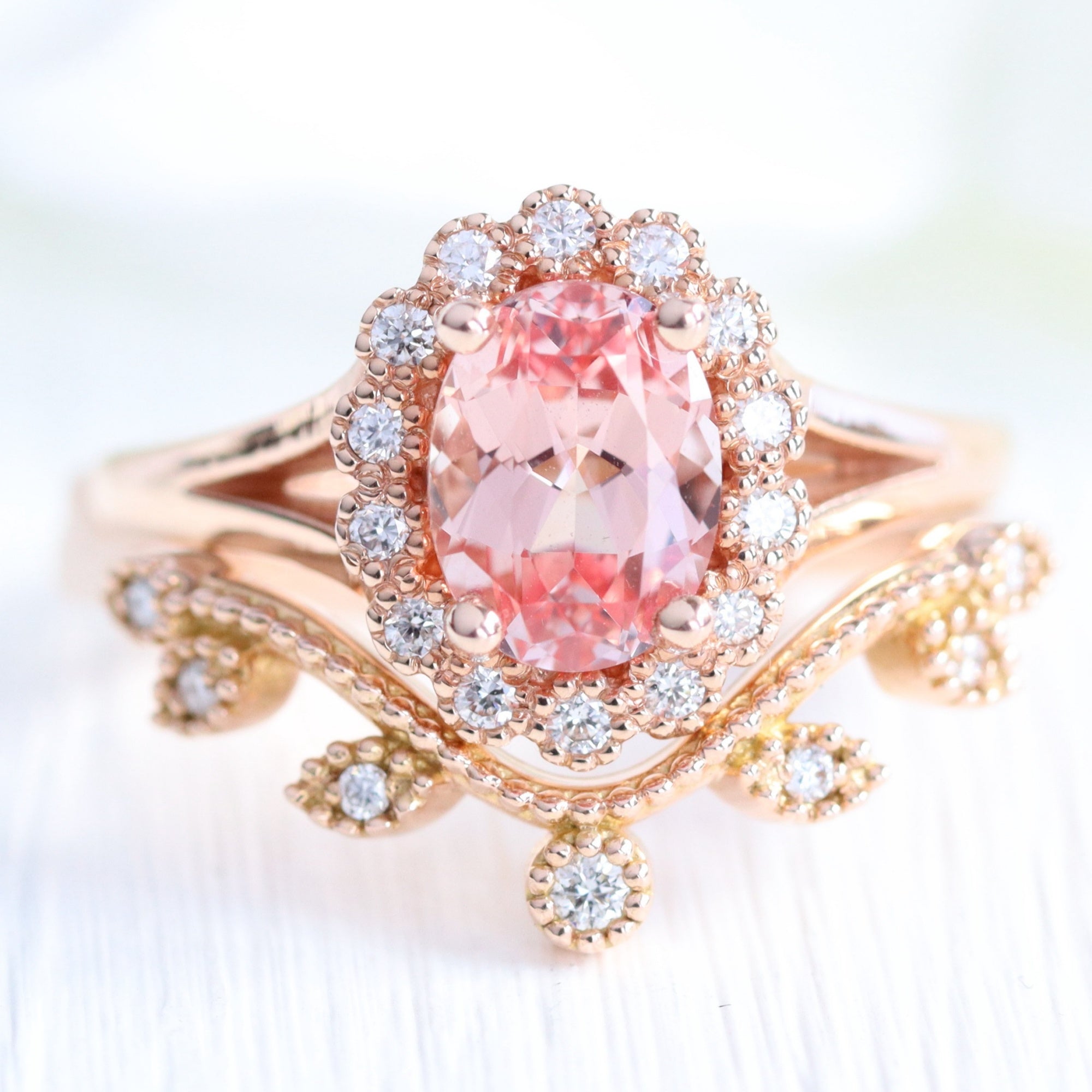 oval peach sapphire ring and curved diamond band in rose gold bridal set by la more design
