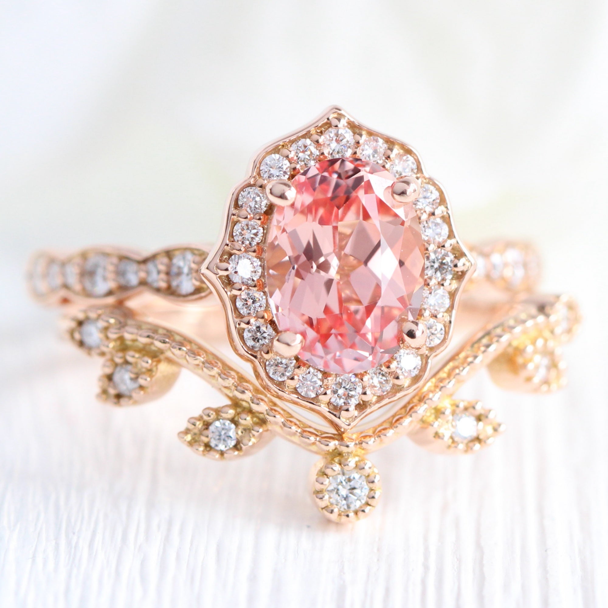 oval peach sapphire ring and curved diamond band in rose gold bridal set by la more design