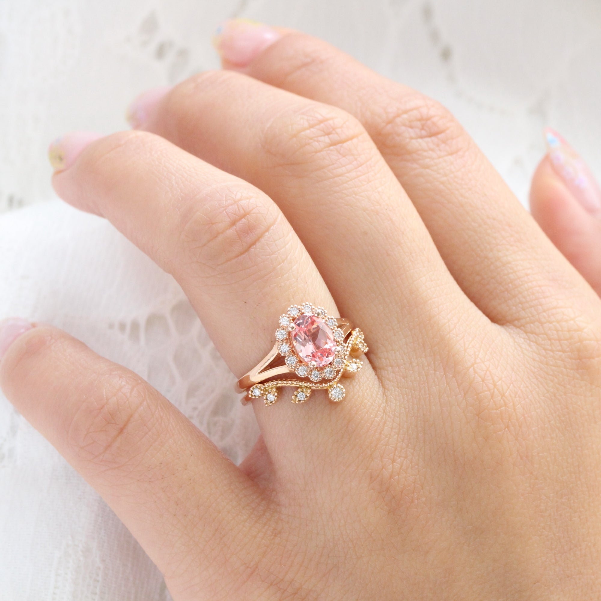 oval peach sapphire ring and curved diamond band in rose gold bridal set by la more design