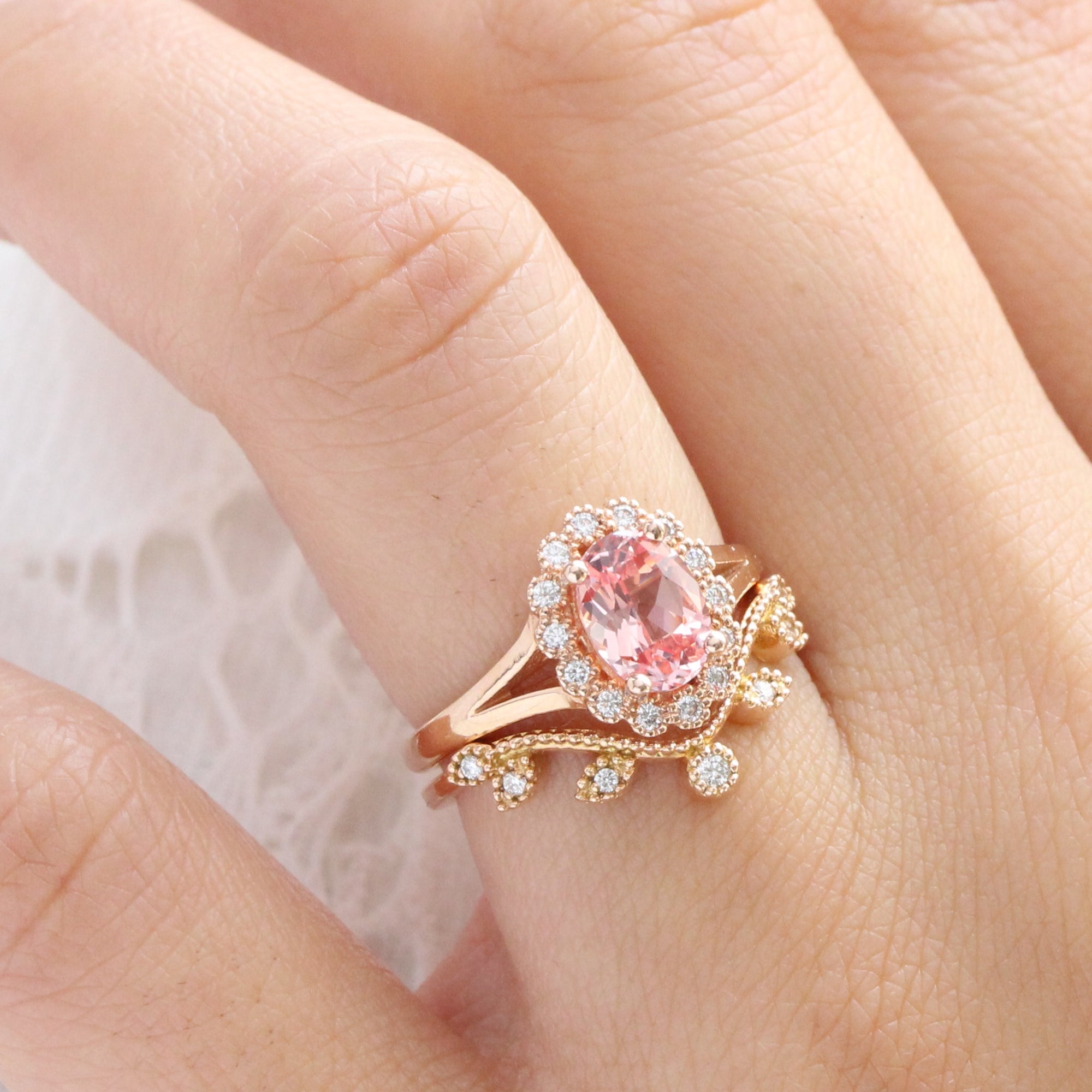 oval peach sapphire ring and curved diamond band in rose gold bridal set by la more design