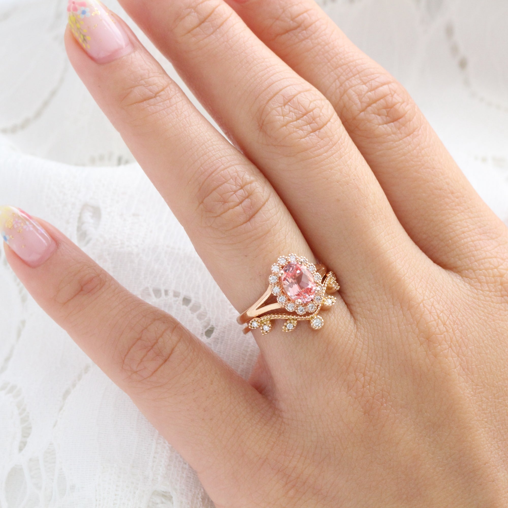 oval peach sapphire ring and curved diamond band in rose gold bridal set by la more design