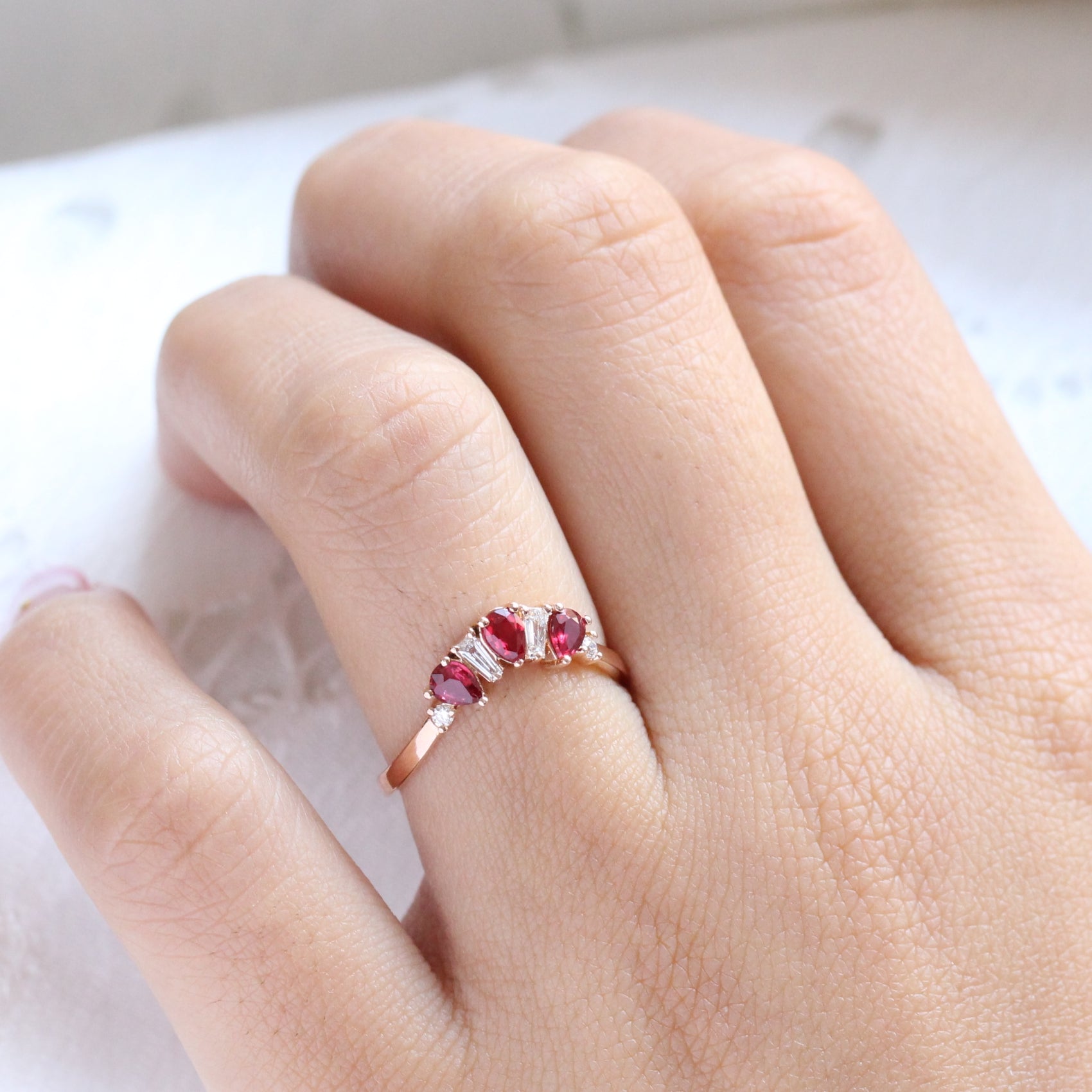 pear and baguette diamond and ruby ring rose gold curved wedding band by la more design jewelry