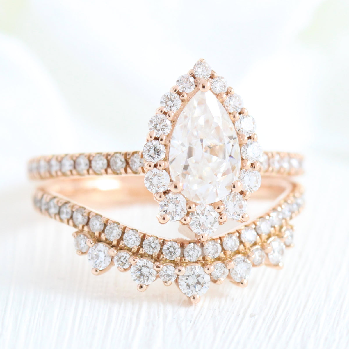 pear moissanite engagement ring rose gold and curved crown diamond wedding band by la more design jewelry