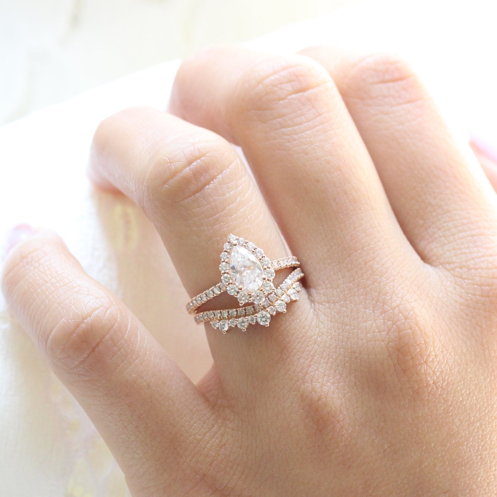 pear moissanite engagement ring rose gold and curved crown diamond wedding band by la more design jewelry