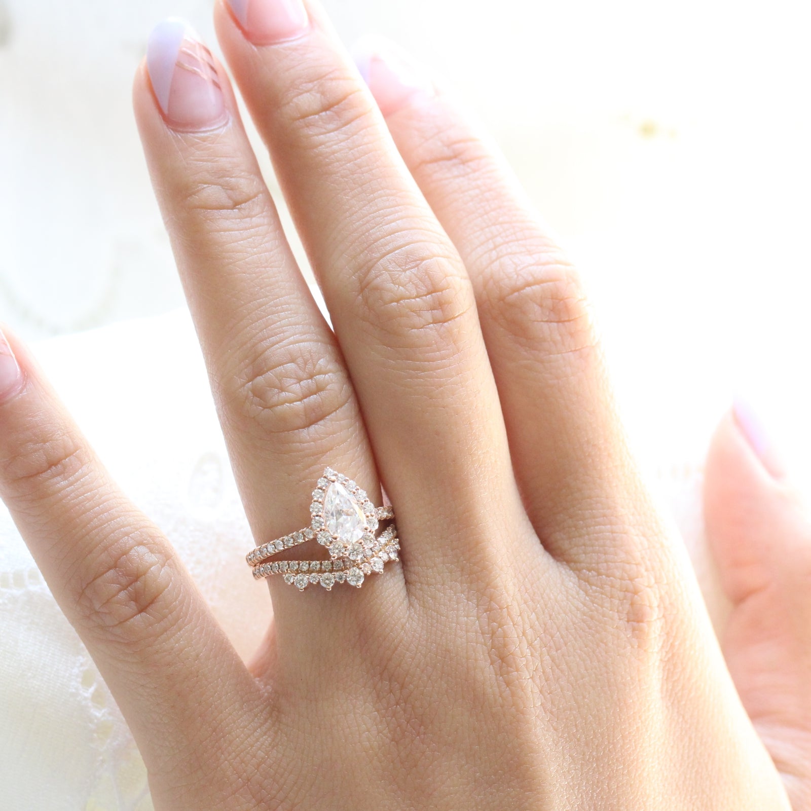 pear moissanite engagement ring rose gold and curved crown diamond wedding band by la more design jewelry