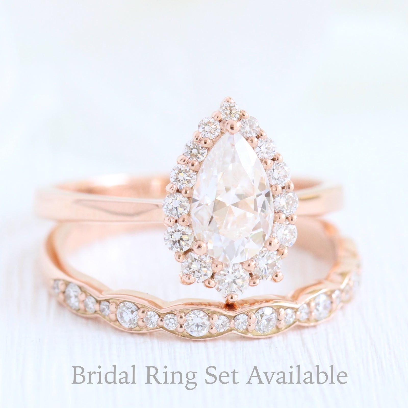 pear moissanite engagement ring rose gold halo diamond ring and matching diamond wedding band by la more design jewelry