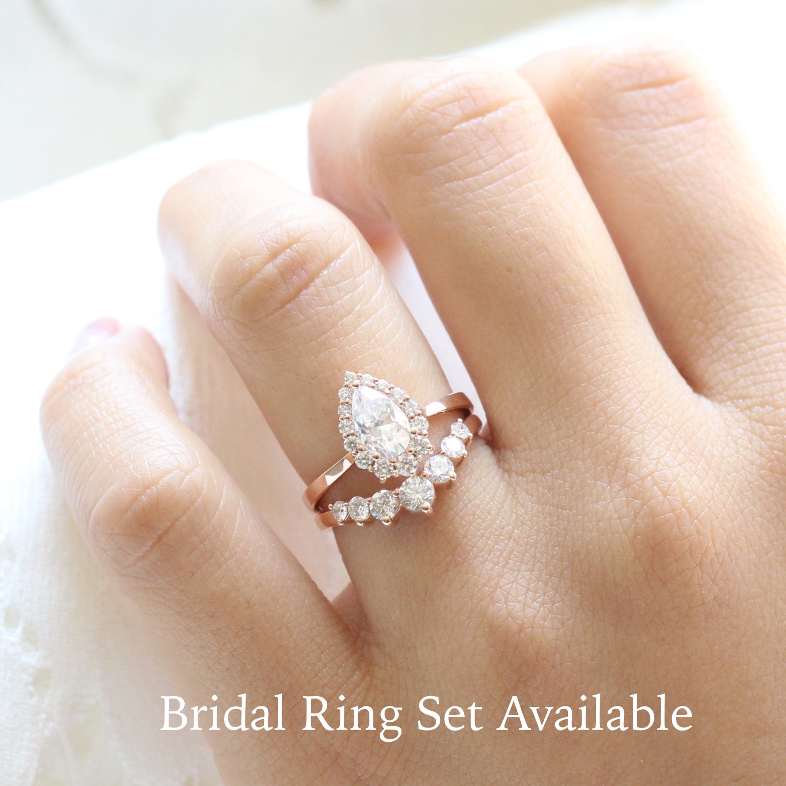 pear moissanite halo diamond engagement ring rose gold and large diamond wedding band by la more design jewelry
