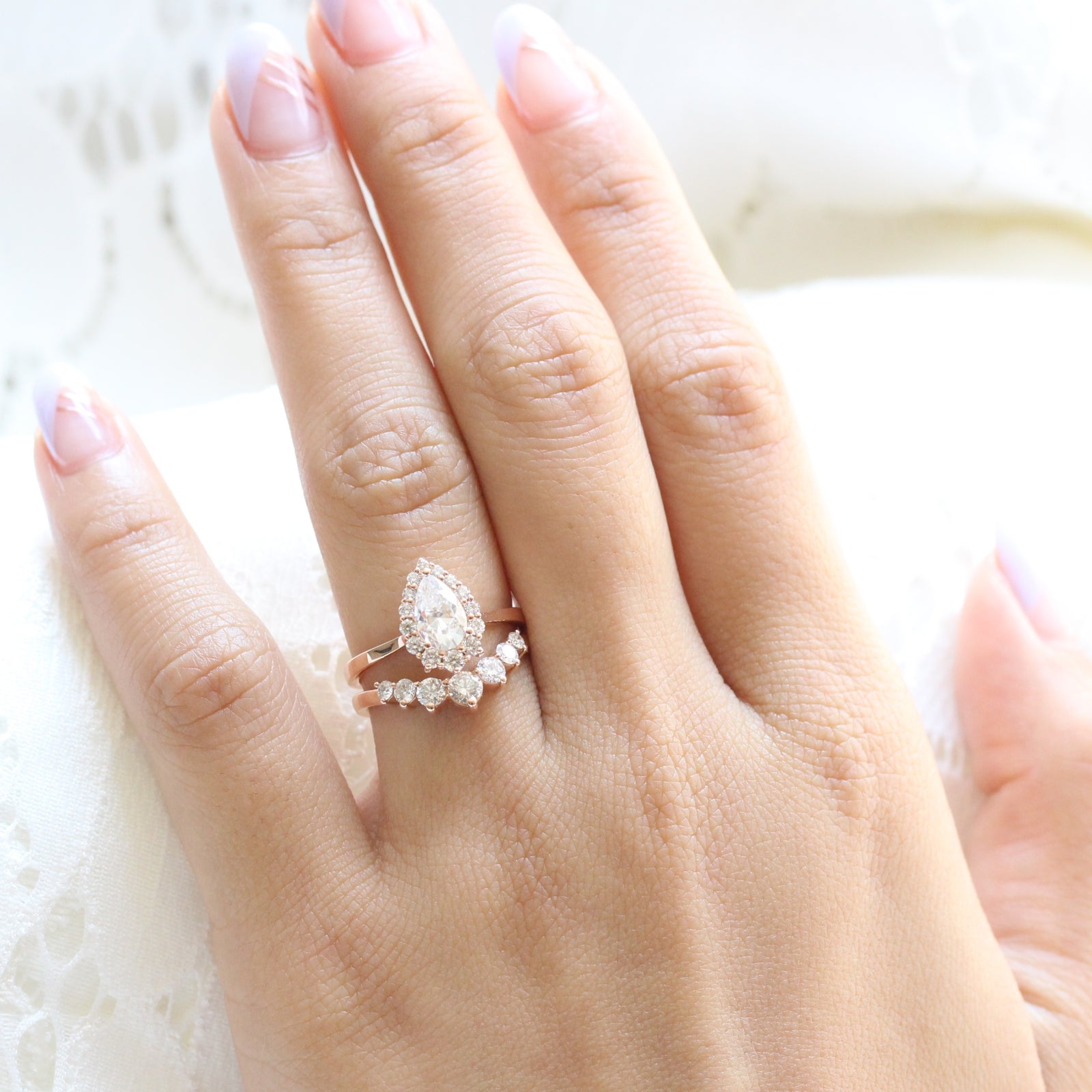 pear moissanite halo diamond engagement ring rose gold and large diamond wedding band by la more design jewelry
