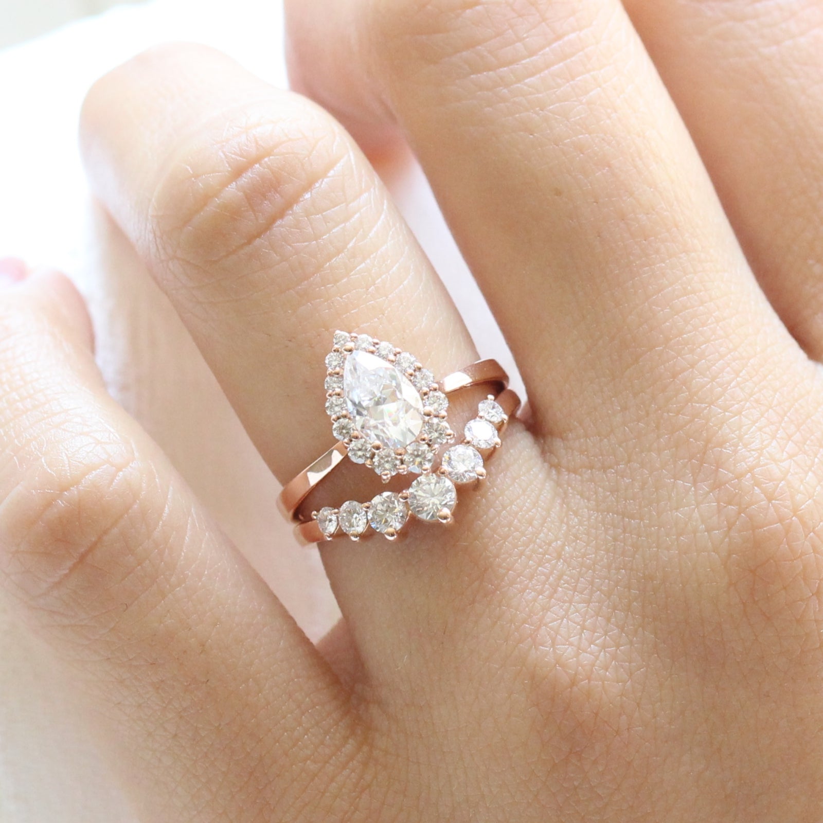 pear moissanite halo diamond engagement ring rose gold and large diamond wedding band by la more design jewelry