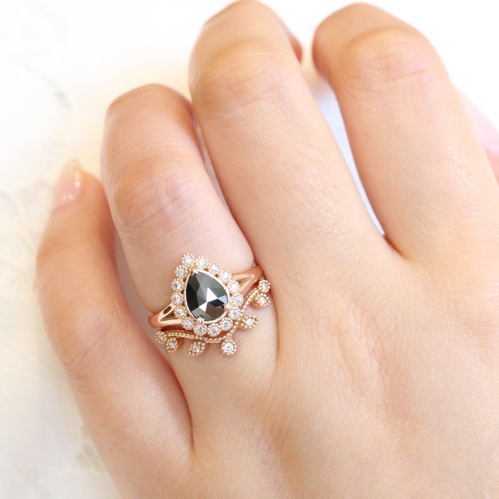 pear rose cut black diamond ring rose gold and curved leaf diamond wedding ring set by la more design