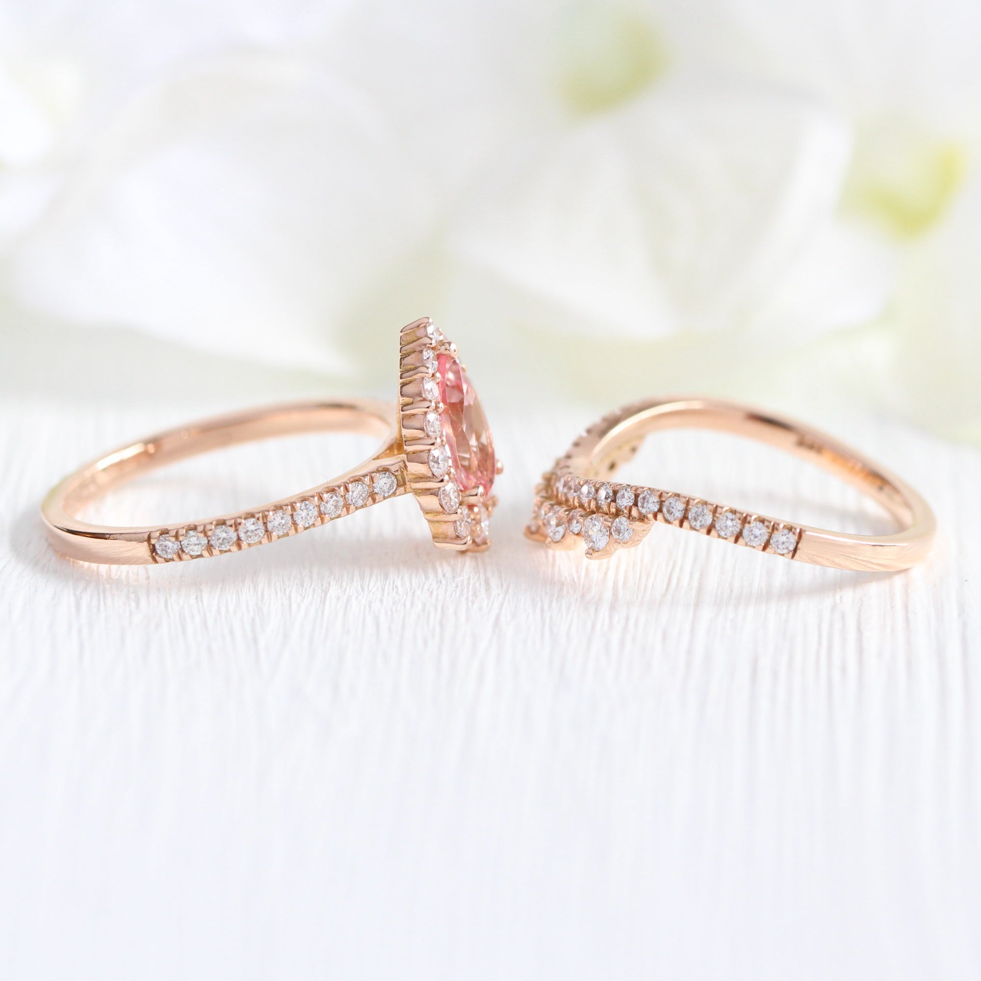 pear shaped peach sapphire engagement ring rose gold and curved crown diamond wedding band by la more design jewelry