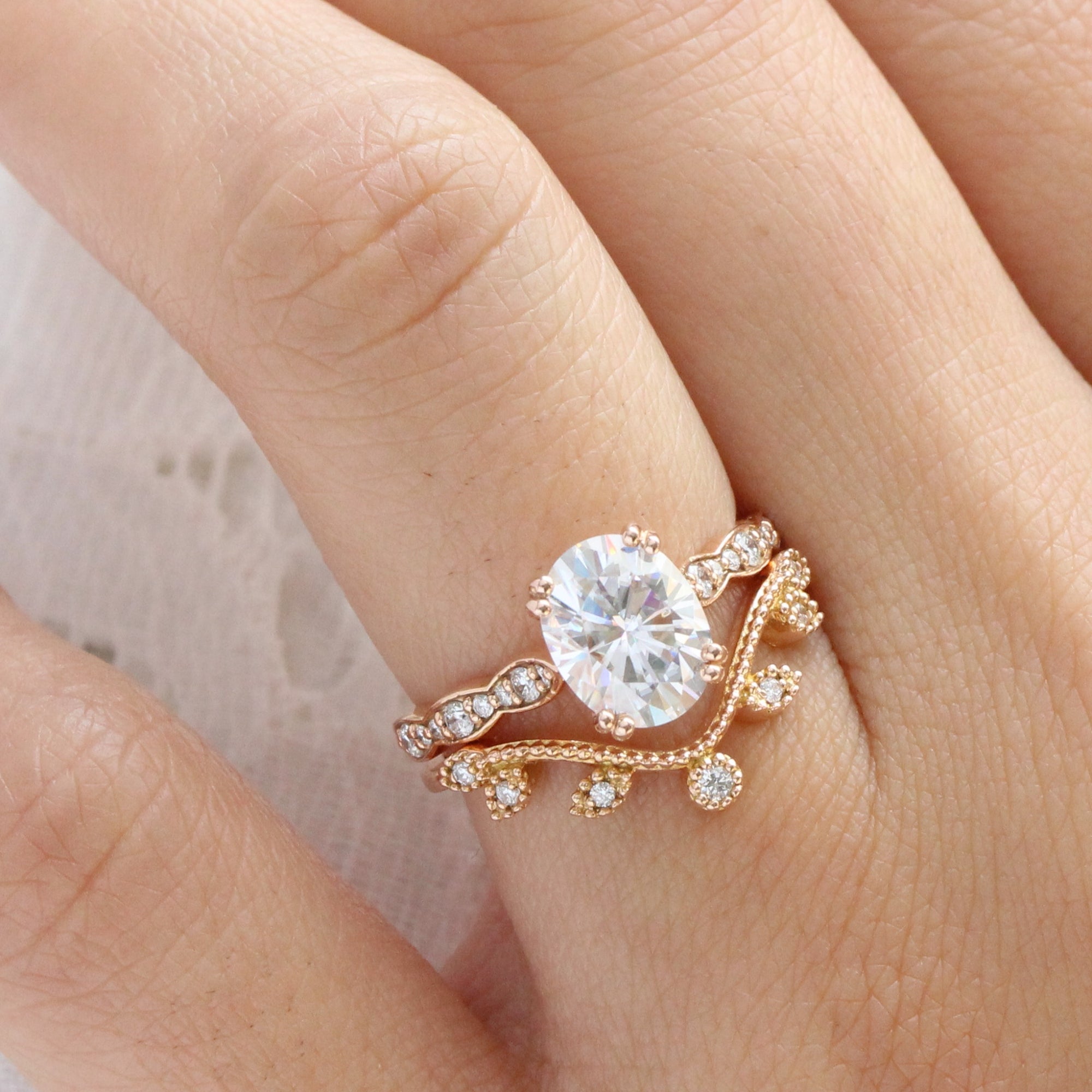 solitaire moissanite ring bridal set in rose gold curved leaf diamond band by la more design jewelry