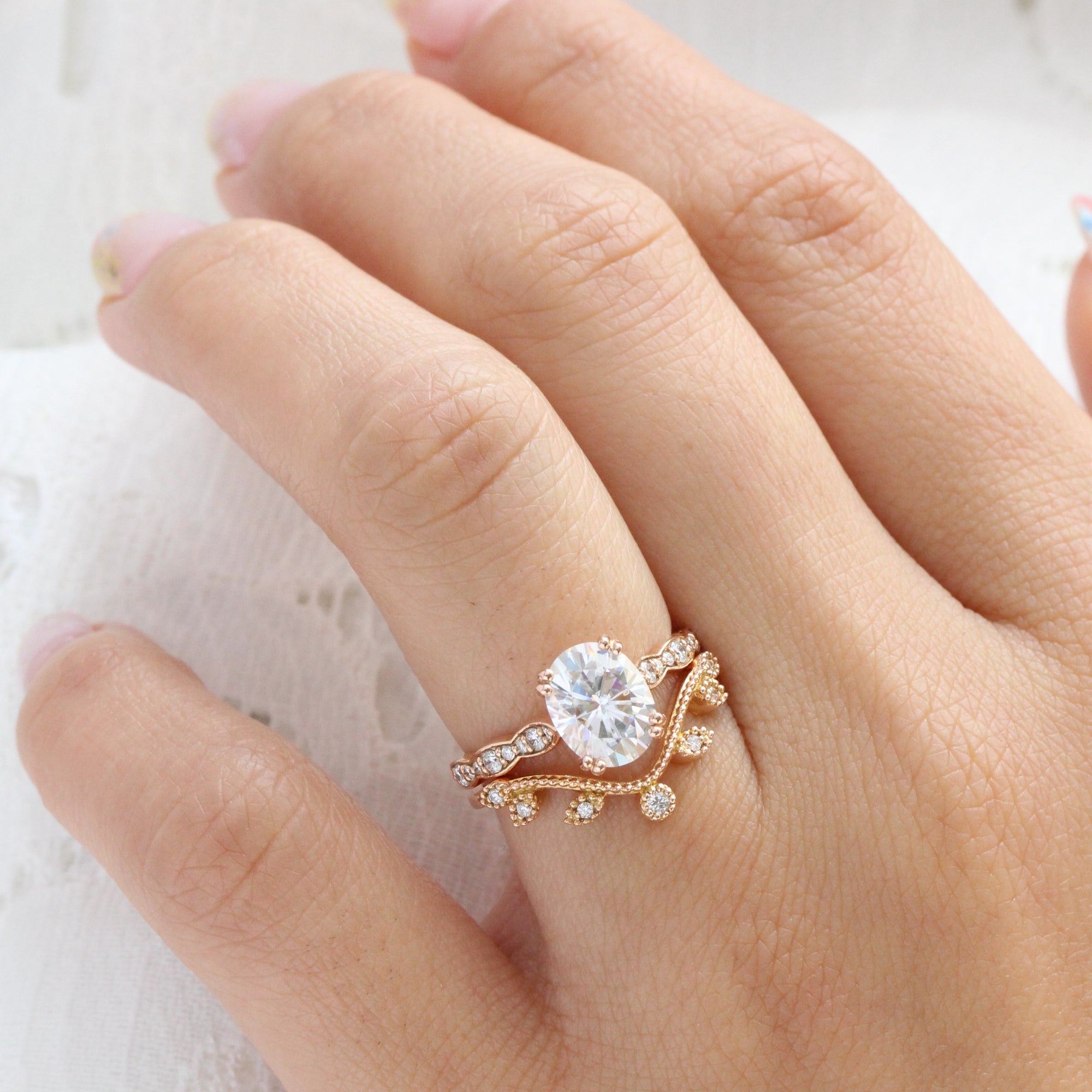 solitaire moissanite ring bridal set in rose gold curved leaf diamond band by la more design jewelry
