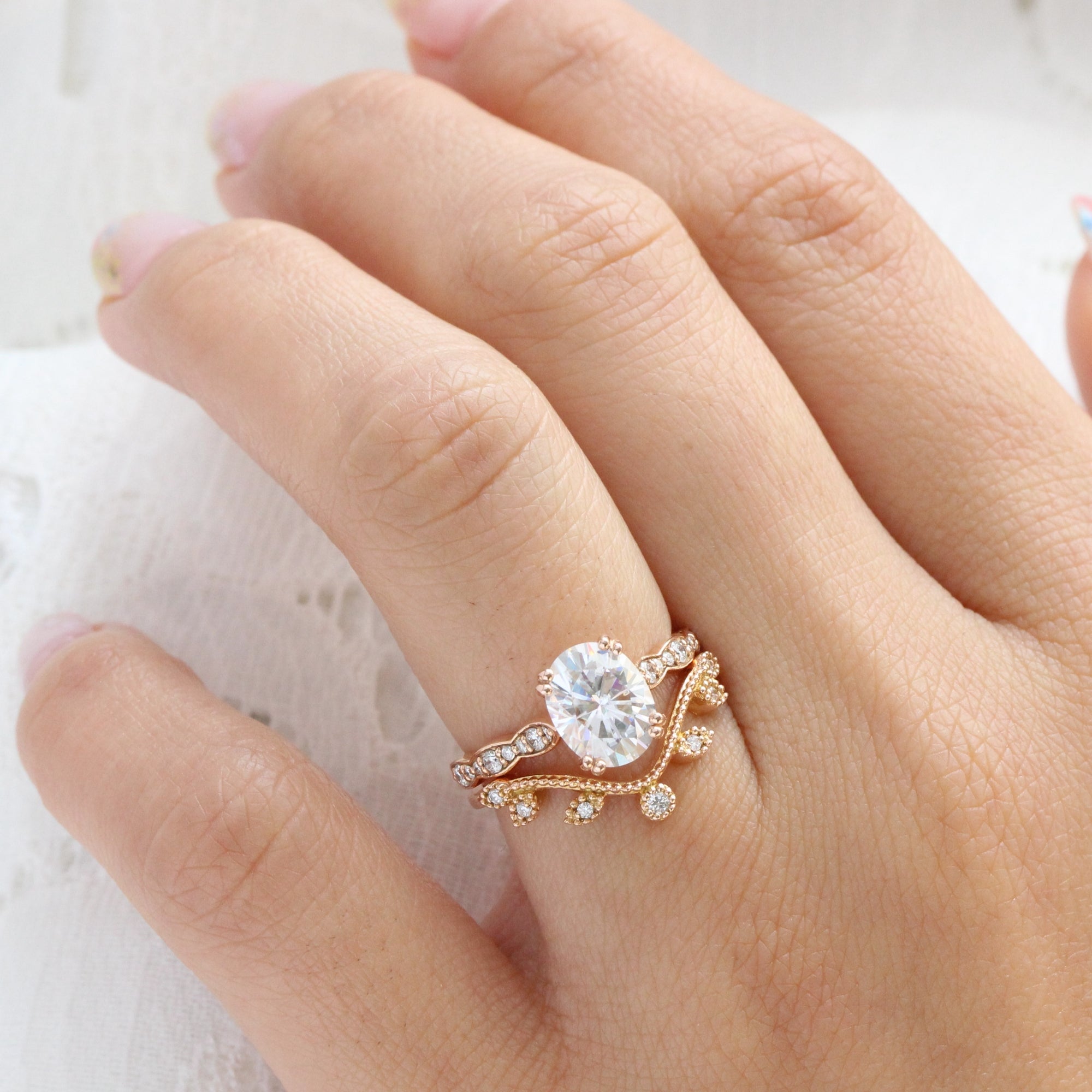 solitaire moissanite ring bridal set in rose gold curved leaf diamond band by la more design jewelry