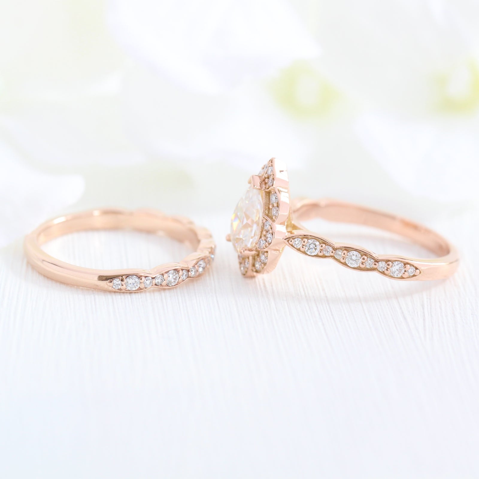 vintage inspired pear moissanite ring and matching diamond wedding band in rose gold bridal set by la more design jewelry