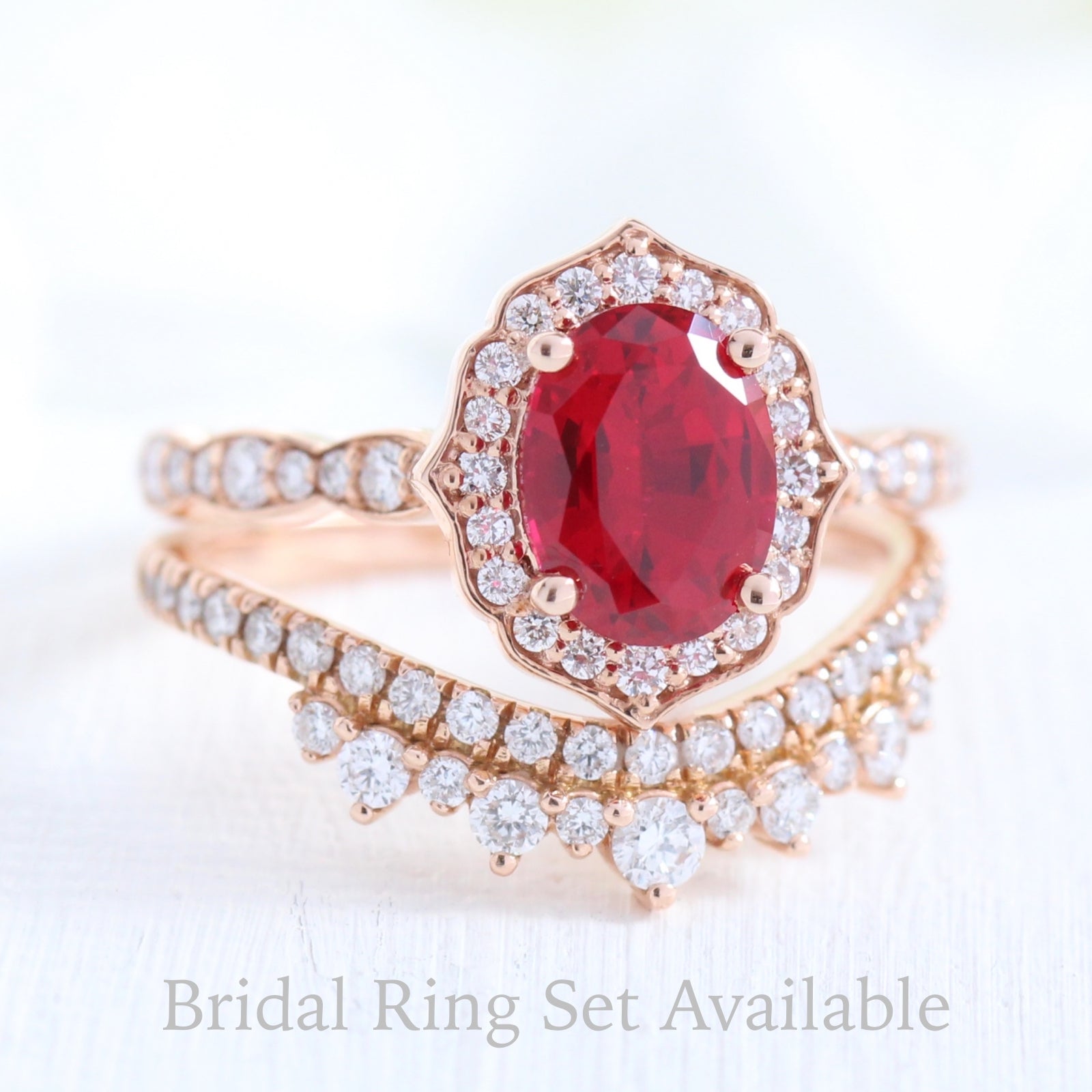 vintage inspired oval ruby ring and crown diamond wedding band in rose gold bridal set by la more design jewelry
