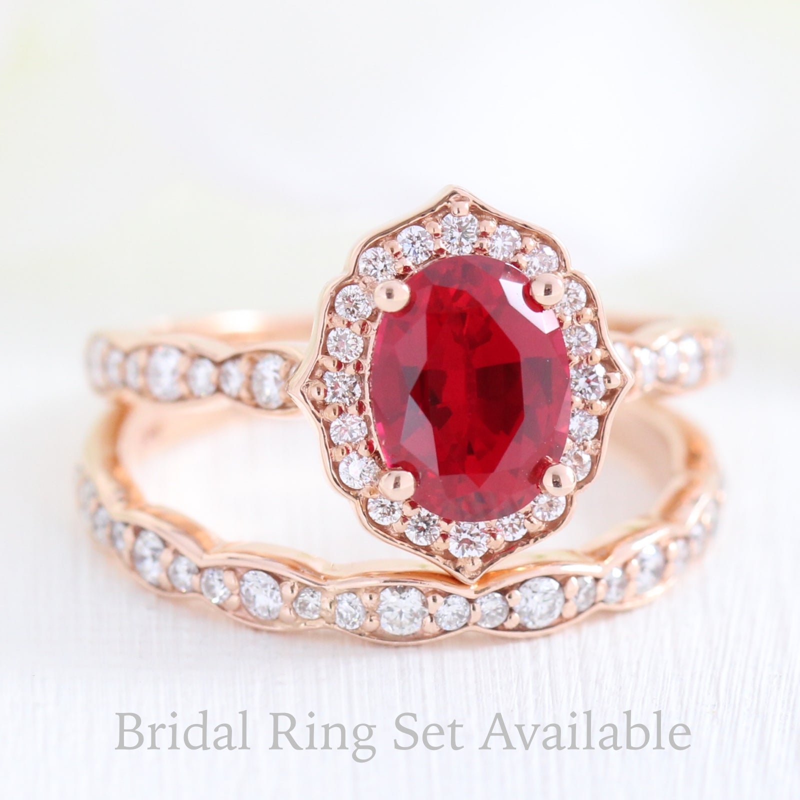vintage inspired oval ruby ring and matching diamond wedding band in rose gold bridal set by la more design jewelry