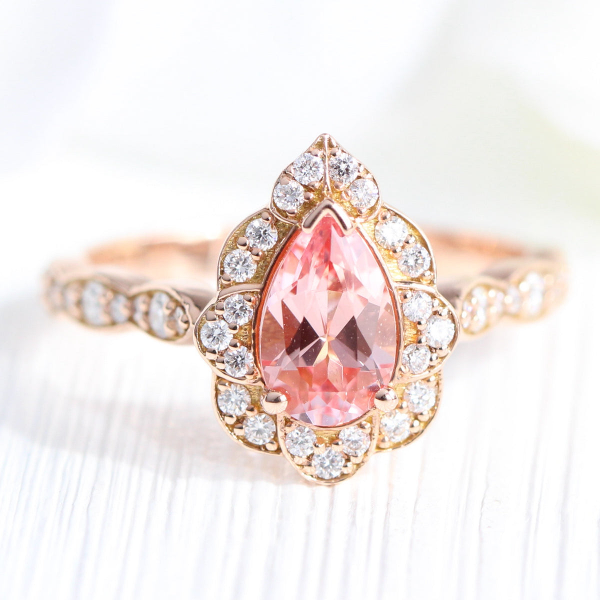vintage inspired peach sapphire pear engagement ring in rose gold curved diamond band by la more design jewelry