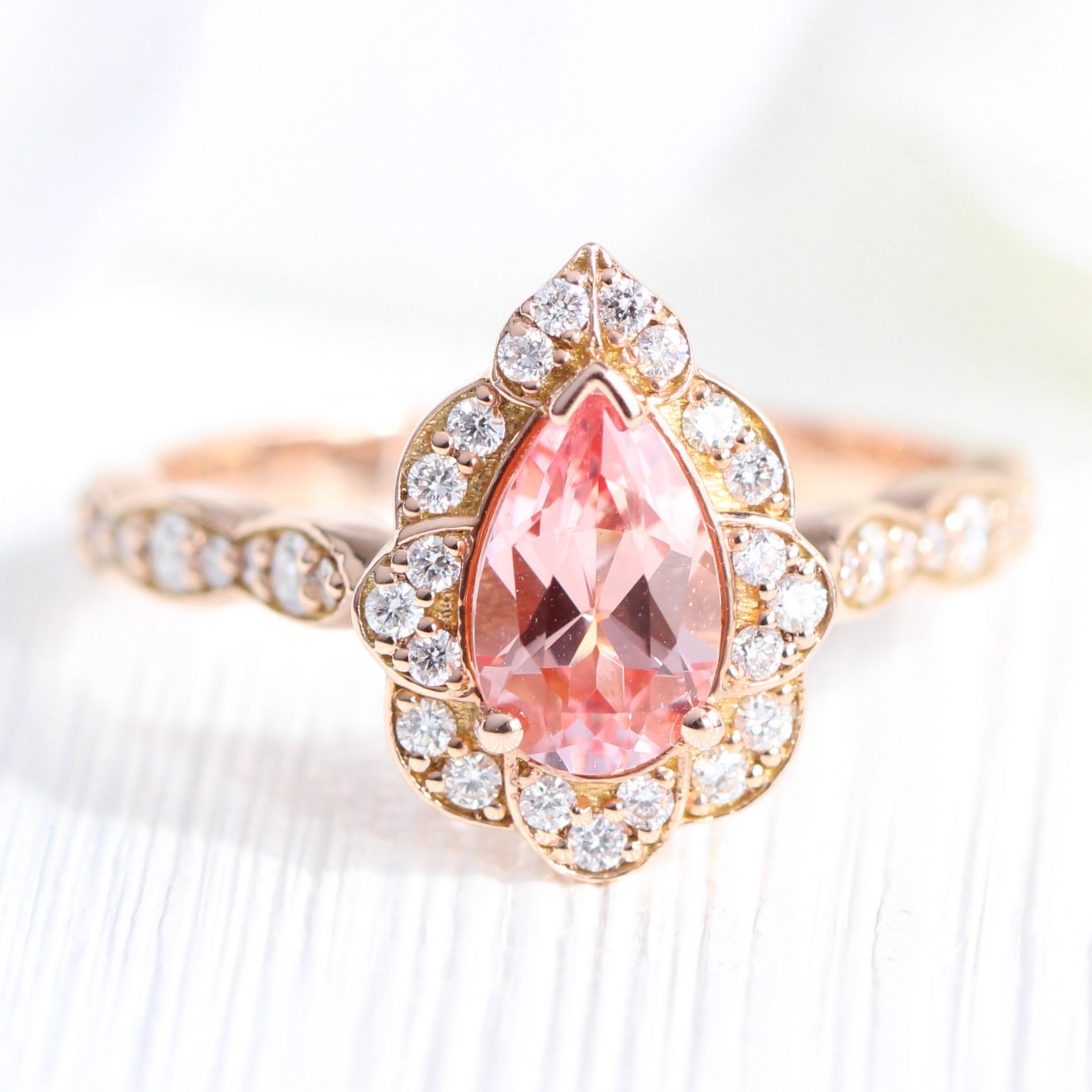 vintage inspired peach sapphire pear engagement ring in rose gold curved diamond band by la more design jewelry