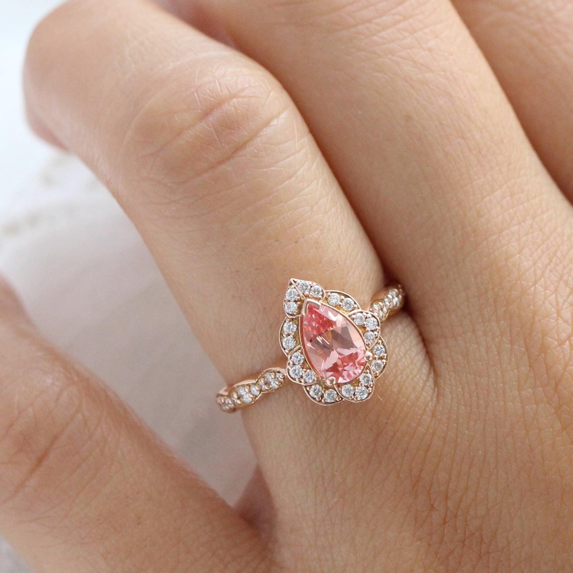 vintage inspired peach sapphire pear engagement ring in rose gold curved diamond band by la more design jewelry