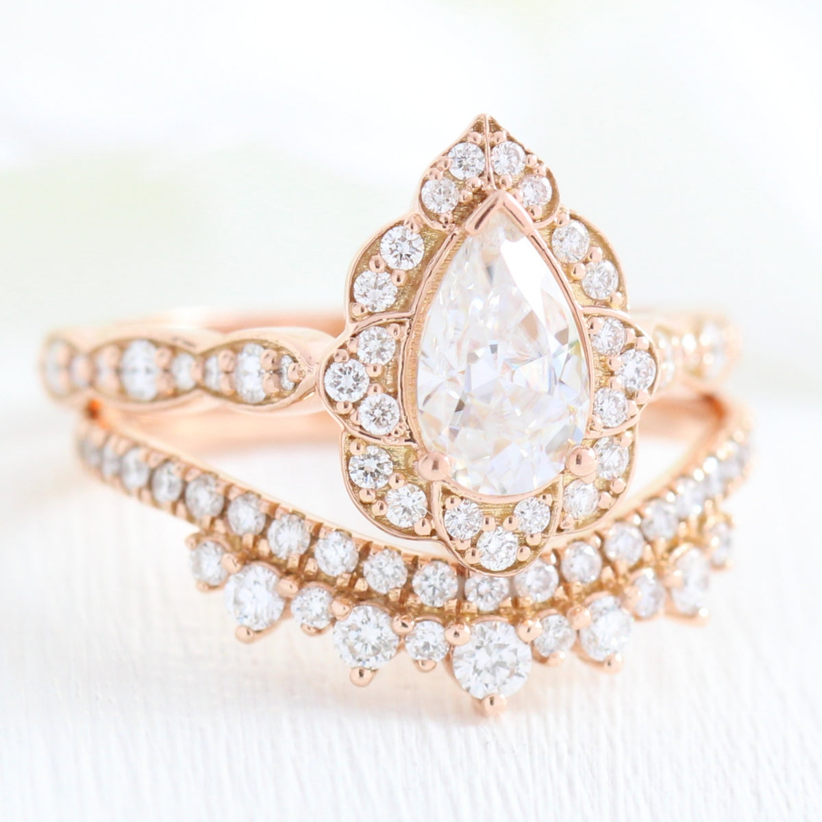 vintage inspired pear moissanite ring and crown diamond wedding band in rose gold bridal set by la more design jewelry